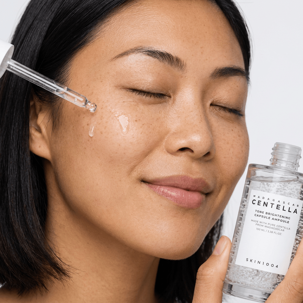 Model Mei applying serum with a glass dropper — SKIN1004 Madagascar Centella Tone Brightening Capsule Ampoule